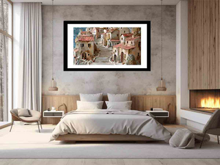 Framed artwork above a bed in a modern bedroom with a fireplace.