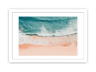 Framed artwork of a beach scene with blue water and pink sand.