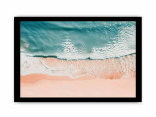 Framed artwork of ocean waves crashing onto a beach