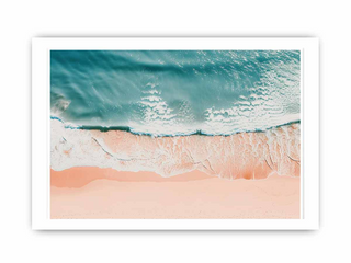 Framed artwork of a beach scene with turquoise water and pink sand.