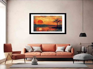 Framed artwork of a sunset over water with a tree, displayed above an orange sofa in a living room.