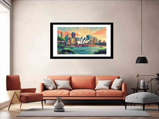 Framed artwork of a cityscape with a sunset over water, displayed on a wall above a sofa in a living room.