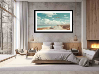 Modern bedroom with a large framed artwork of a beach scene on the wall.