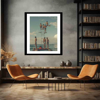 Framed artwork of people by a lifeguard tower on a wall in a room with chairs and books.