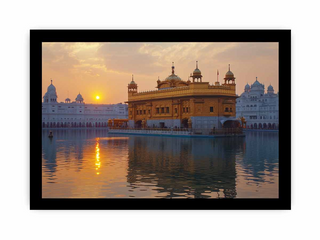 Golden Temple reflected in water with a sunset sky