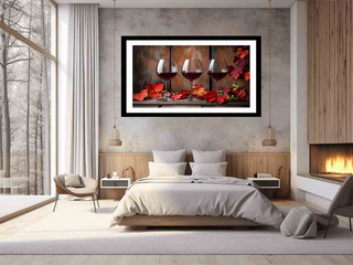 Framed artwork of wine glasses and flowers above a bed in a modern bedroom.