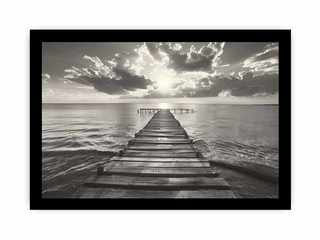 Black and white image of a wooden pier extending into the ocean with dramatic clouds above.