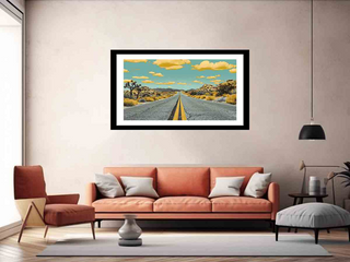 Framed artwork of a desert road on a wall above a sofa in a living room.