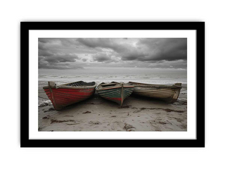 Three boats on a beach with a stormy sky