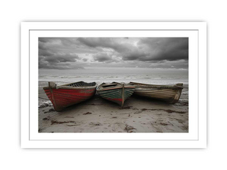 Three boats on a beach with a stormy sky