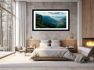 Modern bedroom with a large framed landscape print on the wall.