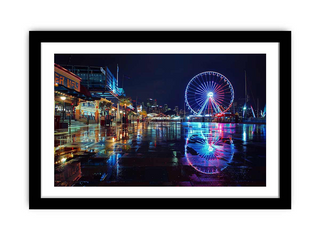 Framed photograph of a Ferris wheel at night with reflections on water