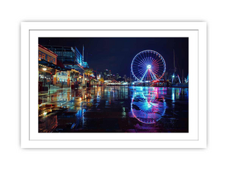 Framed photograph of a Ferris wheel at night with reflections on water.