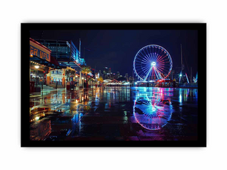 Ferris wheel at night with city skyline reflection on water