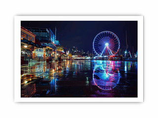 Ferris wheel at night with city skyline reflection on water