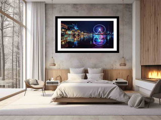 Framed artwork of a cityscape with a Ferris wheel in a bedroom setting.