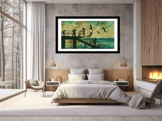 Framed artwork above a bed in a modern bedroom with a fireplace.