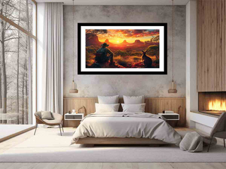 Framed artwork of a desert landscape with animals on a wall above a bed in a modern bedroom.