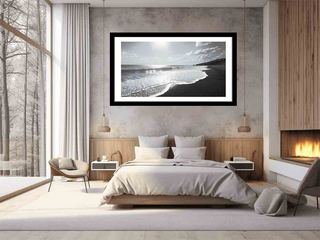 Modern bedroom with a framed beach scene on the wall