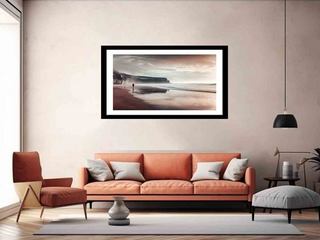 Living room with an orange sofa, armchair, and framed artwork on the wall.