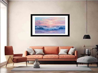 Framed artwork of a sunset over water hanging on a wall above a sofa in a living room.