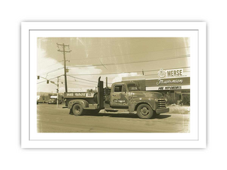 Vintage truck in front of a building with 'Merse' sign, framed photo.