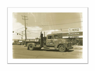 Vintage truck parked in front of a store with a sign reading 'Merse'.