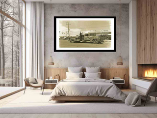 Modern bedroom with a framed black and white photograph of a fire truck on the wall.
