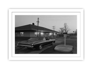 Vintage car parked in front of a building at dusk.