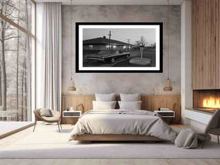 Modern bedroom with a framed black and white photograph of a car on the wall.