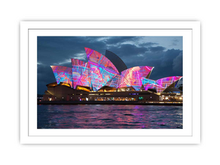 Framed artwork of the Sydney Opera House with colorful lights against a dark sky.