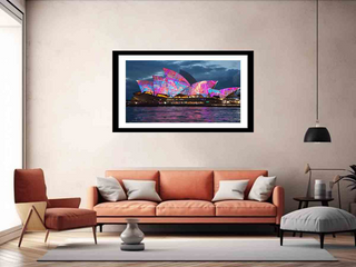 Framed artwork of a colorful Sydney Opera House in a living room setting.