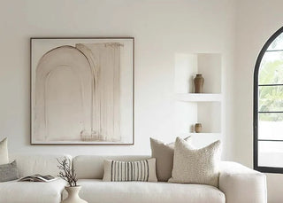 Modern living room with a white sofa, wooden coffee table, and decorative items.